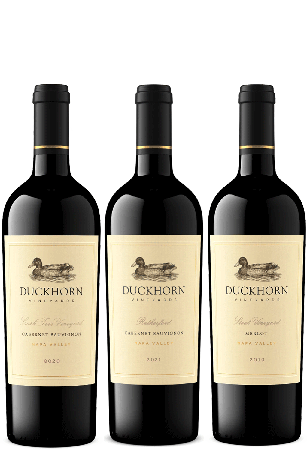 Three bottles of Duckhorn Vineyards red wine arranged side by side on a white background, showing Cabernet Sauvignon and Merlot.