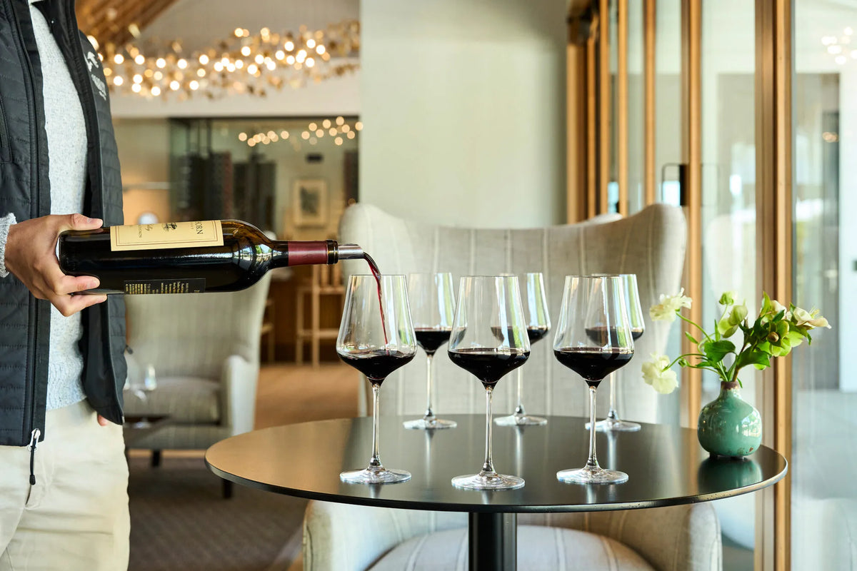 Wine being poured into tasting glasses during a winery experience
