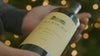 Person holding a bottle of Duckhorn Vineyards wine